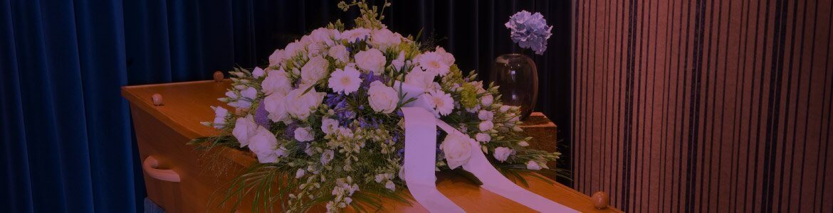 Image of a floral arrangement on a coffin for colin fisher funeral directors orpington and bromley for family run funeral directors